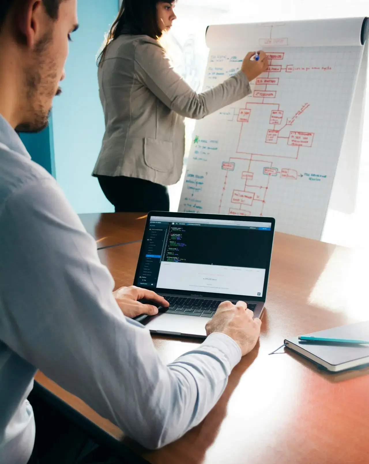 person wearing grey dress shirt beside table